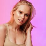 a beautiful blonde woman posing for a picture